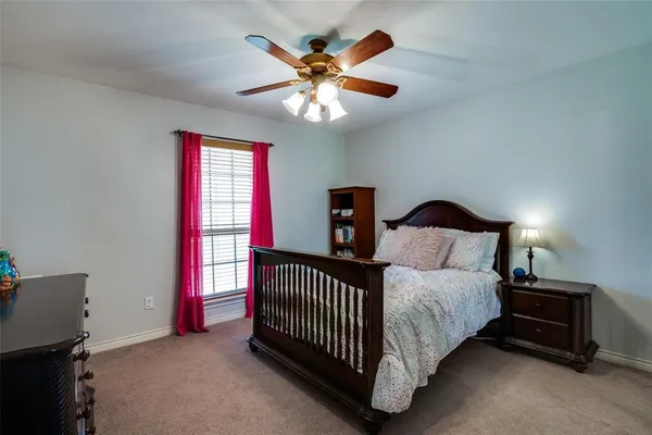 a bedroom with a bed and window