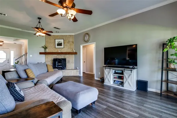 a living room with furniture a flat screen tv and a fireplace