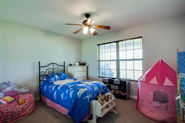 a bed room with a bed and a window