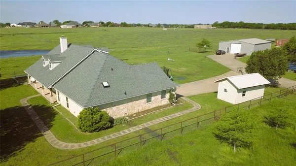 an aerial view of a house with outdoor space and a lake view