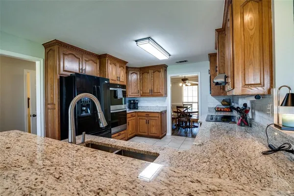 a kitchen with refrigerator and window