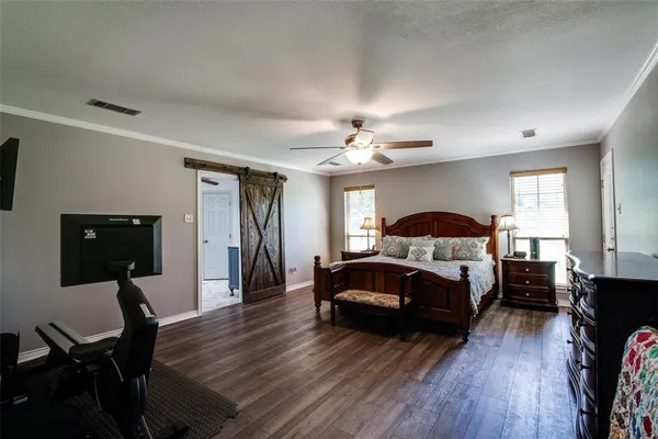 a bedroom with furniture and a wooden floor