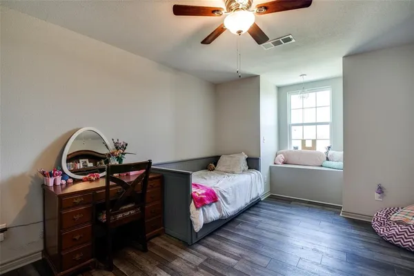 a bedroom with furniture and wooden floor