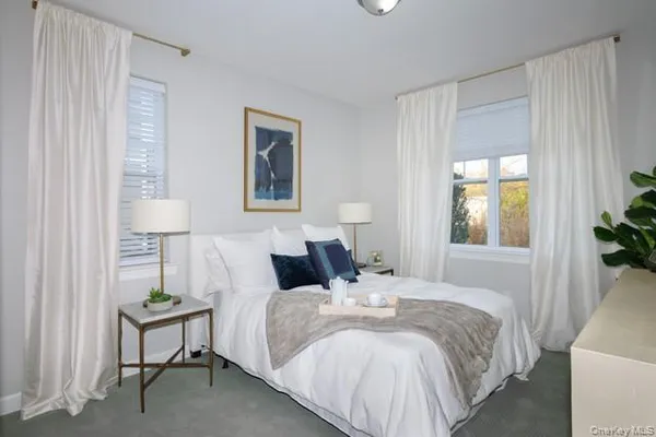 a bedroom with a bed and a lamp on table