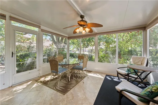 a living room with furniture and floor to ceiling windows