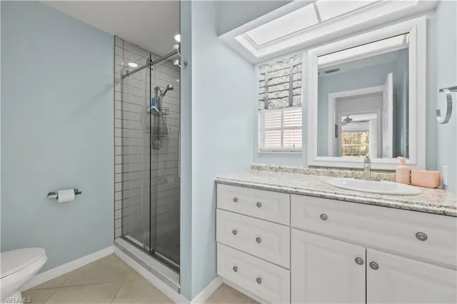 a spacious bedroom with a bed and a tv