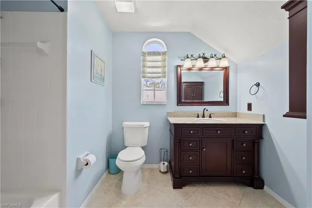 a view of a house with a yard and potted plants