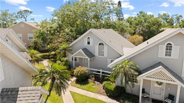 an aerial view of a house with outdoor seating