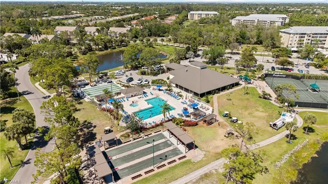 an aerial view of a residential apartment building with a yard