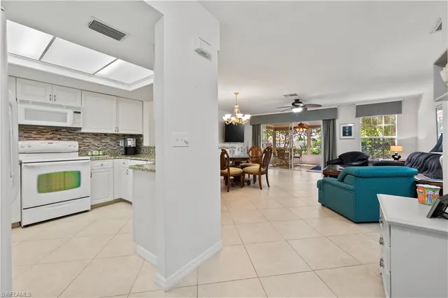 a kitchen with cabinets appliances a sink and a counter top space