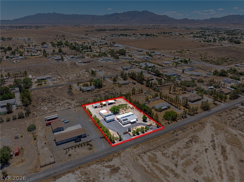 1831 West Horn Road Pahrump, NV 89048 - Photo 52 of 59 An aerial perspective showcases the extensive lot with mountain views, perfect for a secluded retreat.