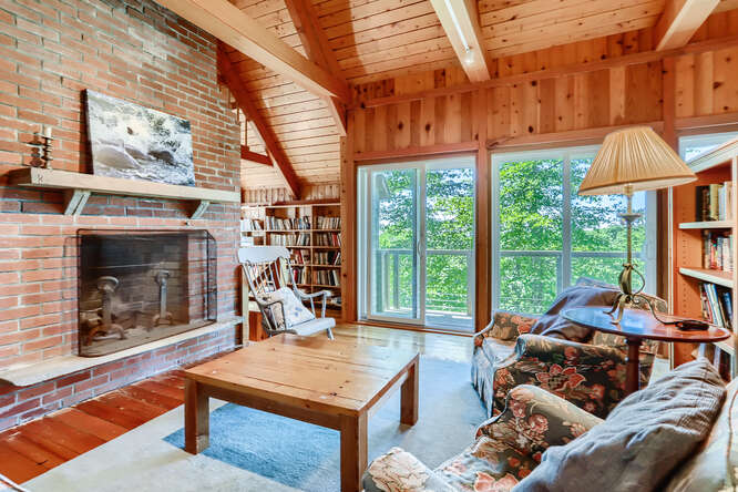 14 Ephriam Allen Road West Tisbury, MA 02568 - Photo 16 of 17 a living room with furniture a table and a fireplace