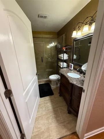 a bathroom with a sink a toilet a mirror and vanity