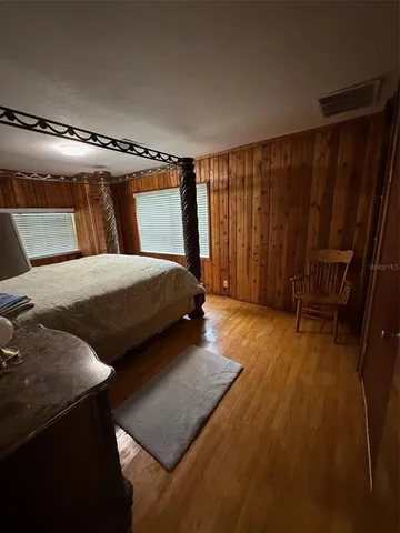 a bedroom with a bed and a chair