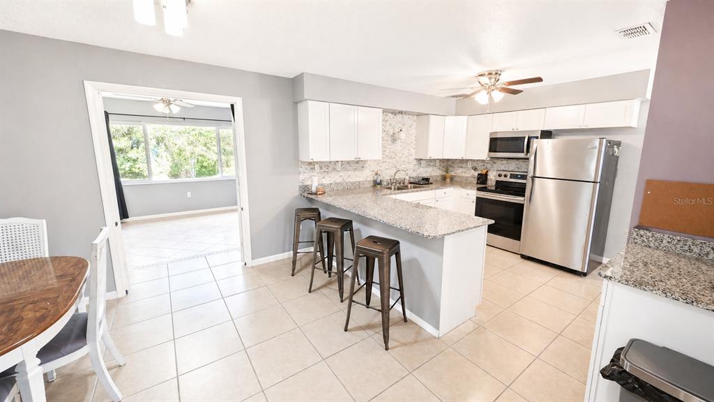 2 Clear Place Ocala, FL 34472 - Photo 11 of 23 a kitchen with stainless steel appliances a table chairs and a refrigerator