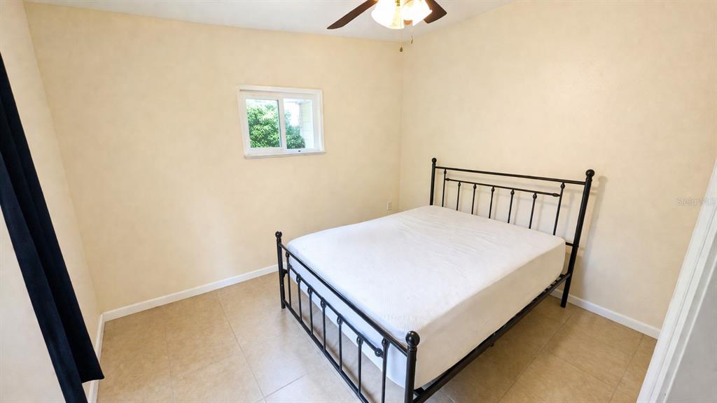 2 Clear Place Ocala, FL 34472 - Photo 16 of 23 a bed room with a bed and a chandelier