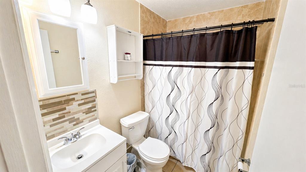 2 Clear Place Ocala, FL 34472 - Photo 19 of 23 a bathroom with a toilet and a shower curtain