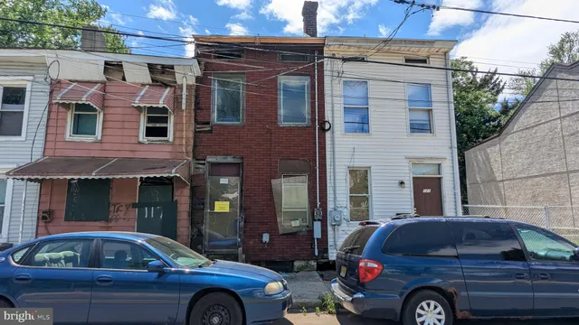 a front view of a house with parking space