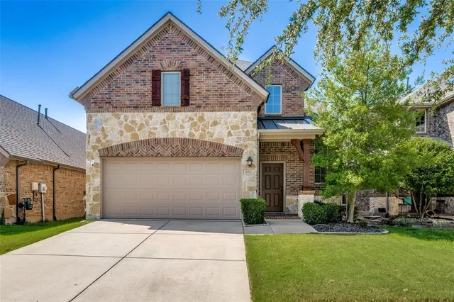 a front view of a house with a garden and plants