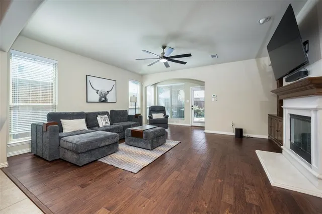 a living room with furniture a fireplace and a flat screen tv
