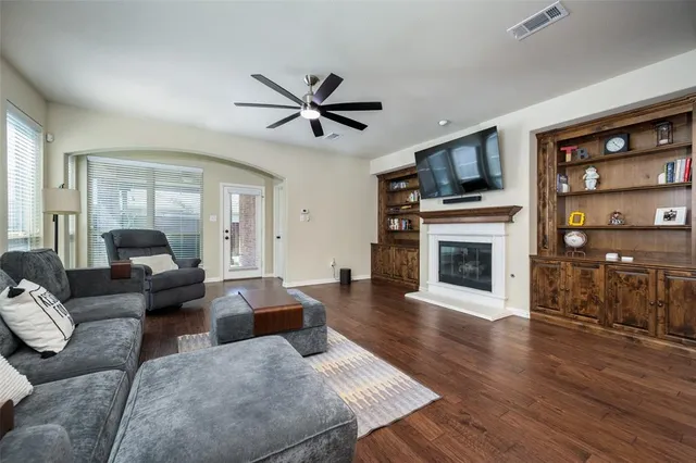 a living room with furniture a fireplace and a flat screen tv
