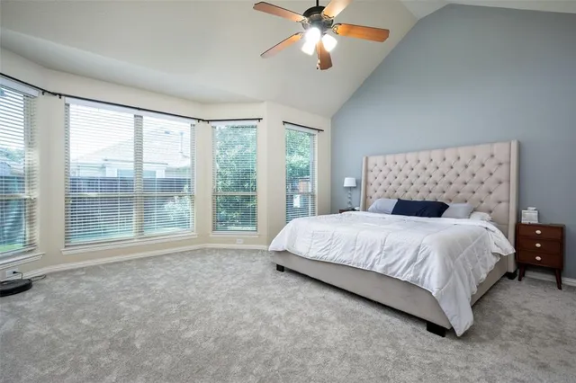 a bedroom with a large bed and a large window