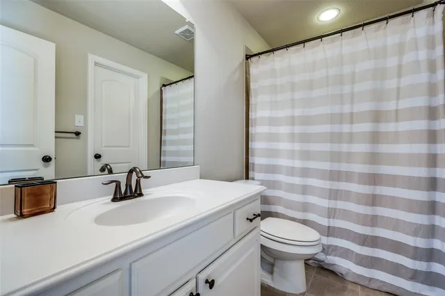 a bathroom with a sink a toilet and mirror