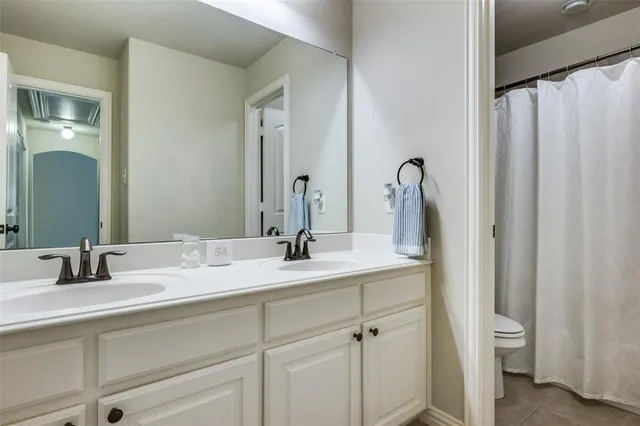 a bathroom with a double vanity sink and mirror