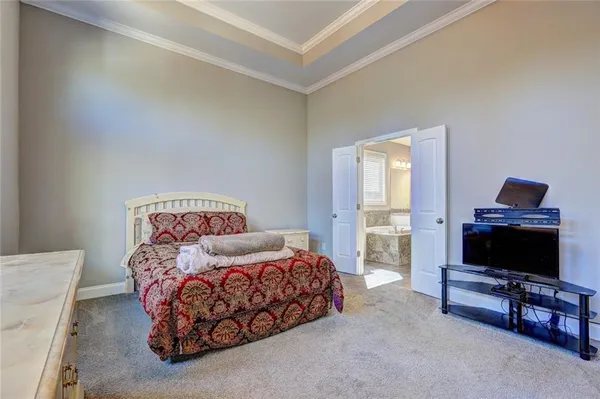 a bedroom with furniture and a flat screen tv