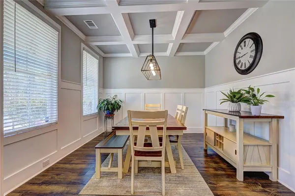 a dining room with a wooden table and chairs