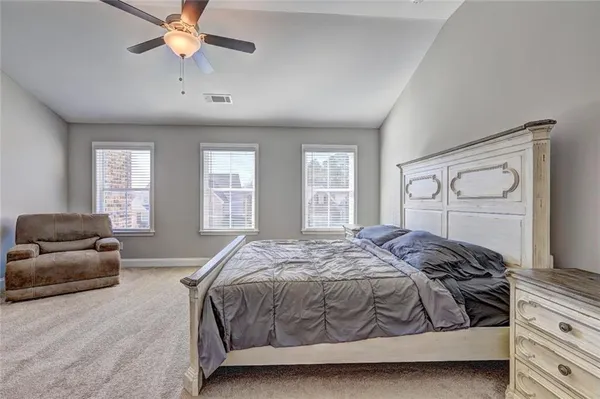 a bedroom with a bed and a couch