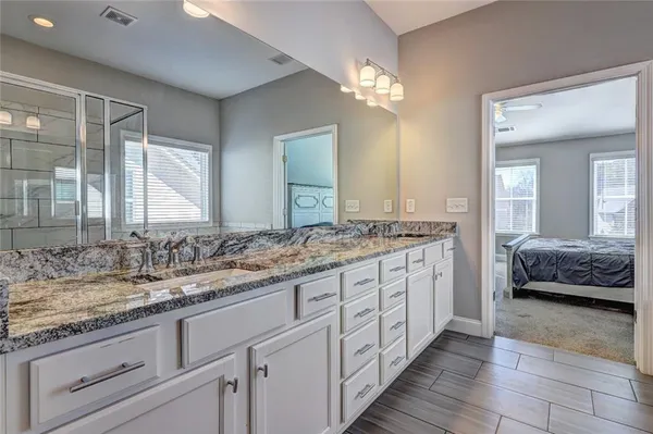 a spacious bathroom with double sink and a mirror