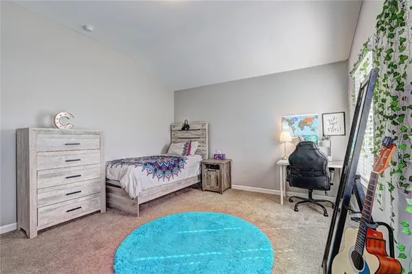a bedroom with furniture and a chair