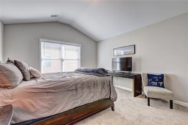 a bedroom with a bed and a couch