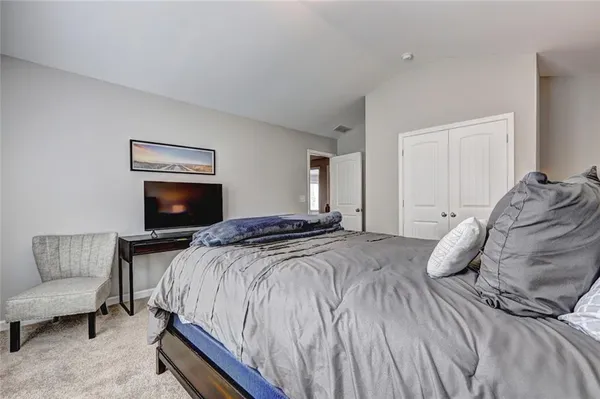 a bedroom with a bed and a couch