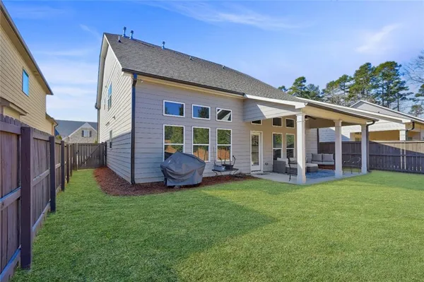a view of a house with backyard and porch