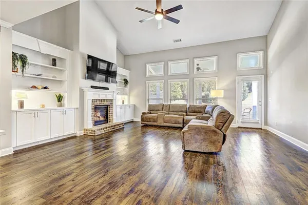 a living room with furniture fireplace and flat screen tv