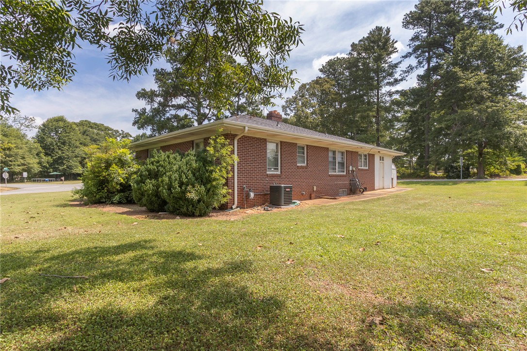 1218 Bolt Drive Anderson, SC 29621 - Photo 37 of 46 A classic brick exterior blends seamlessly with the natural landscape, offering a serene backdrop.
