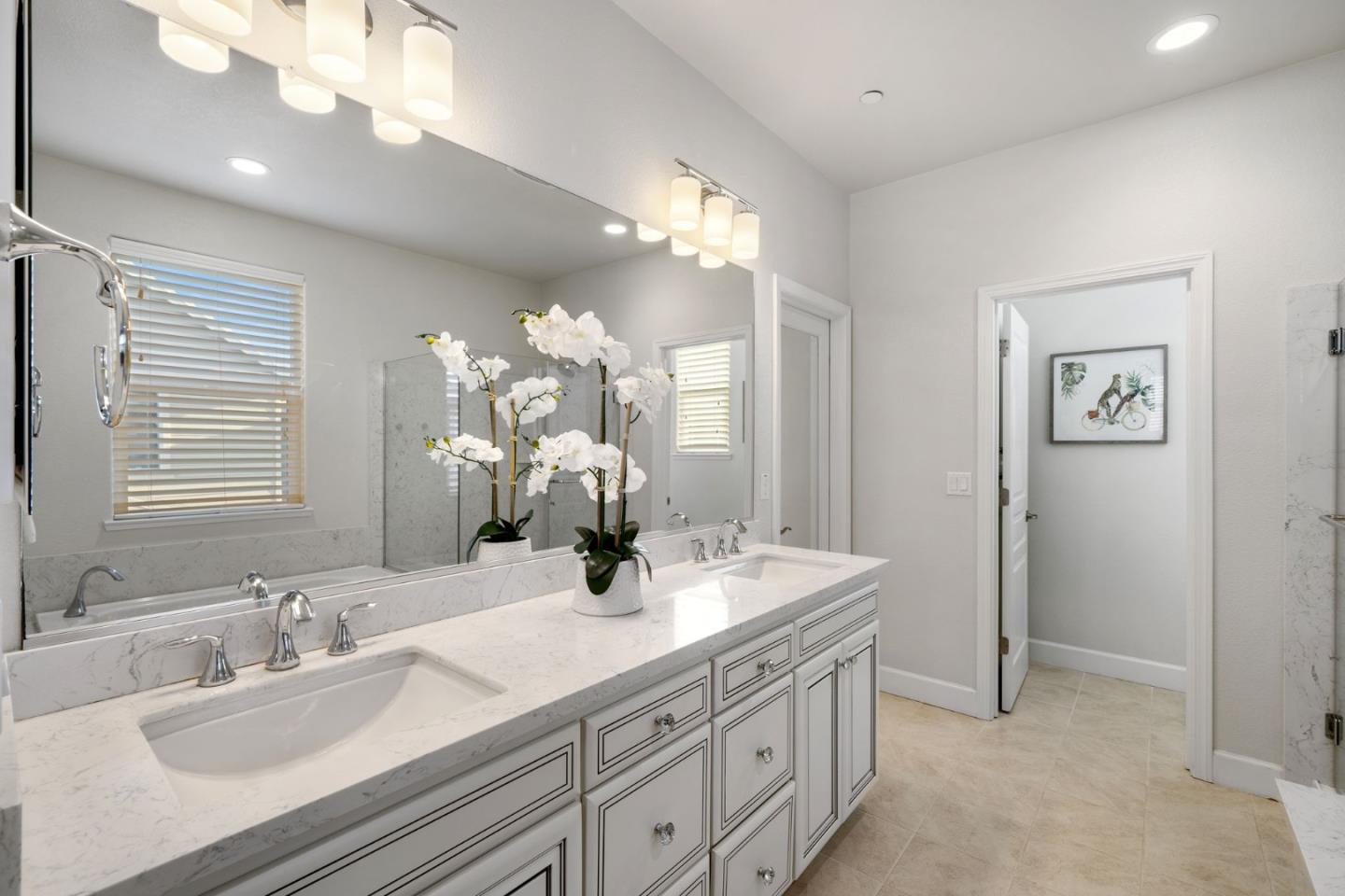11958 Glaskin Place Dublin, CA 94568 - Photo 20 of 41 a bathroom with double vanity sinks a vanity a lamp and a mirror