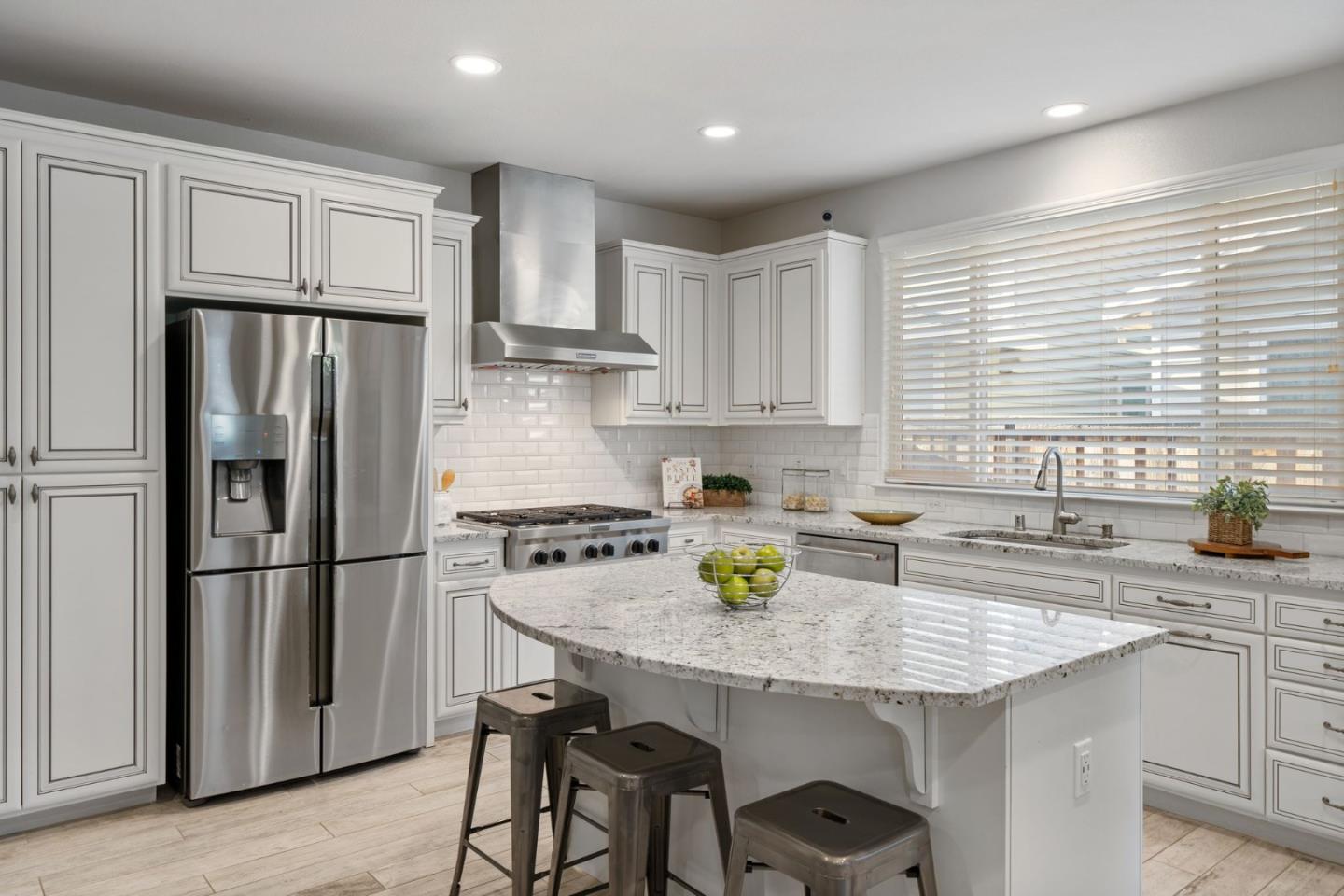 11958 Glaskin Place Dublin, CA 94568 - Photo 9 of 41 a kitchen with stainless steel appliances granite countertop a stove a refrigerator and a sink
