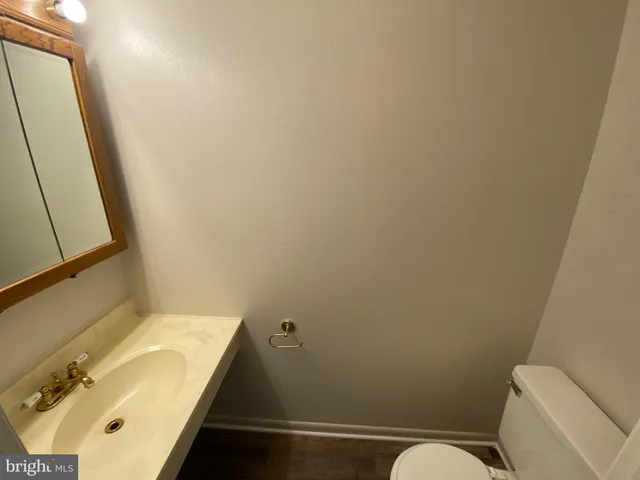 a view of a room with wooden floor and windows