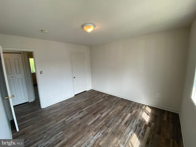 a view of a livingroom with a fireplace and a window
