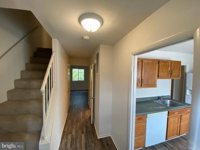 a kitchen with granite countertop a refrigerator and a sink
