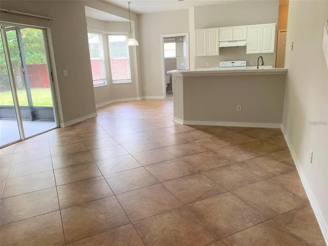a view of a kitchen with an empty space and a window