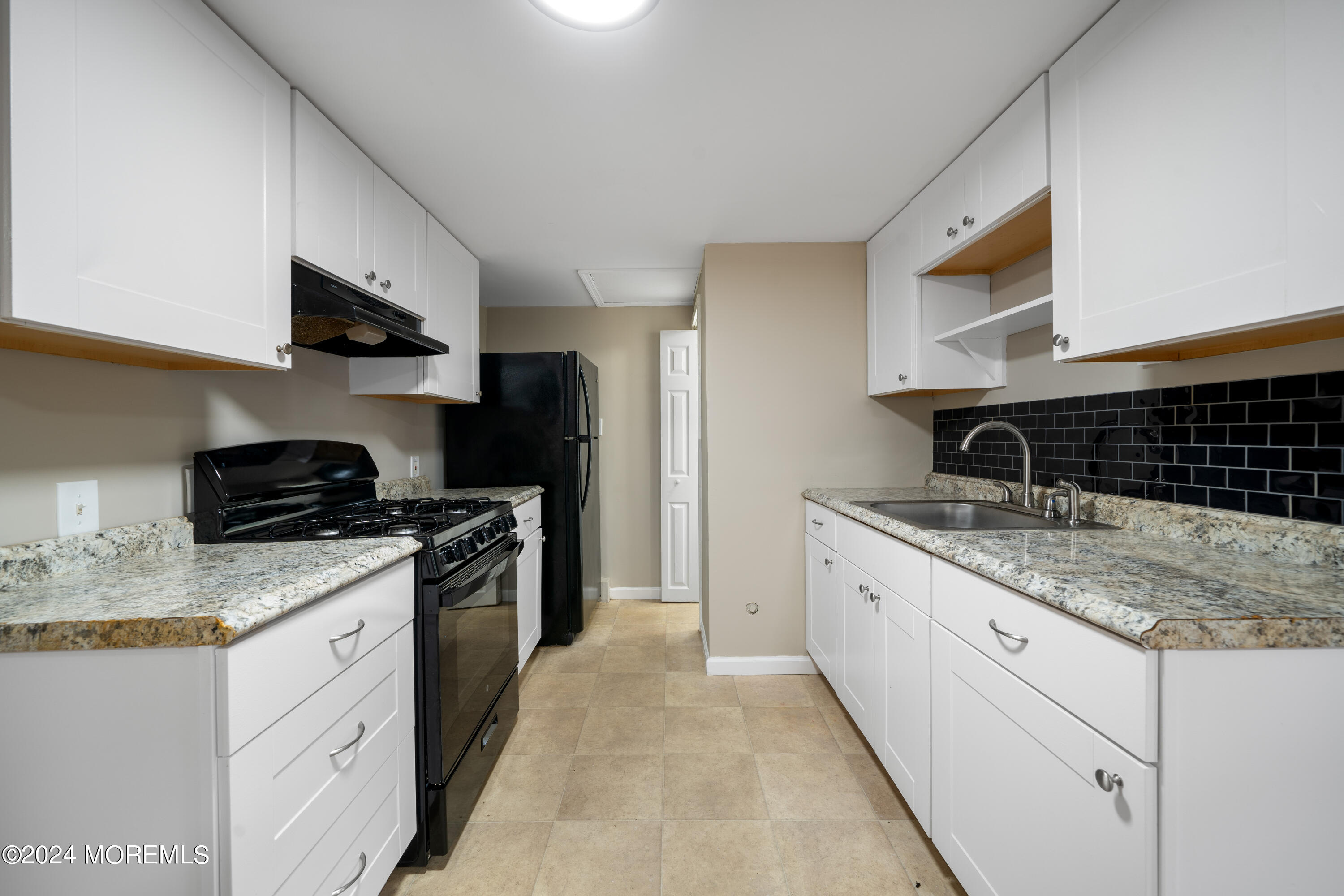 906 Tampa Road Forked River, NJ 08731 - Photo 6 of 21 a kitchen with granite countertop a sink stove and cabinets