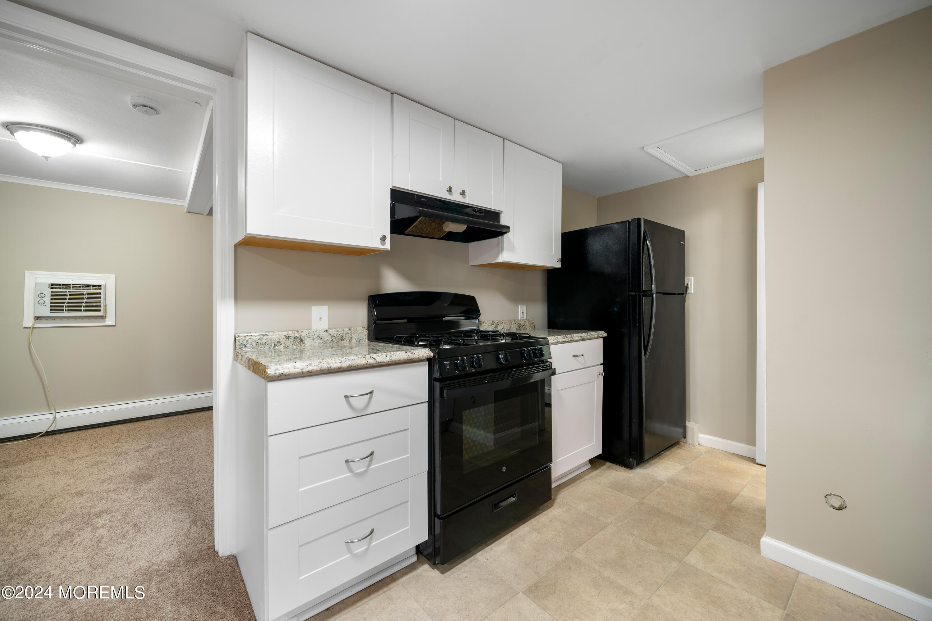 906 Tampa Road Forked River, NJ 08731 - Photo 7 of 21 a kitchen with stainless steel appliances white cabinets and a refrigerator