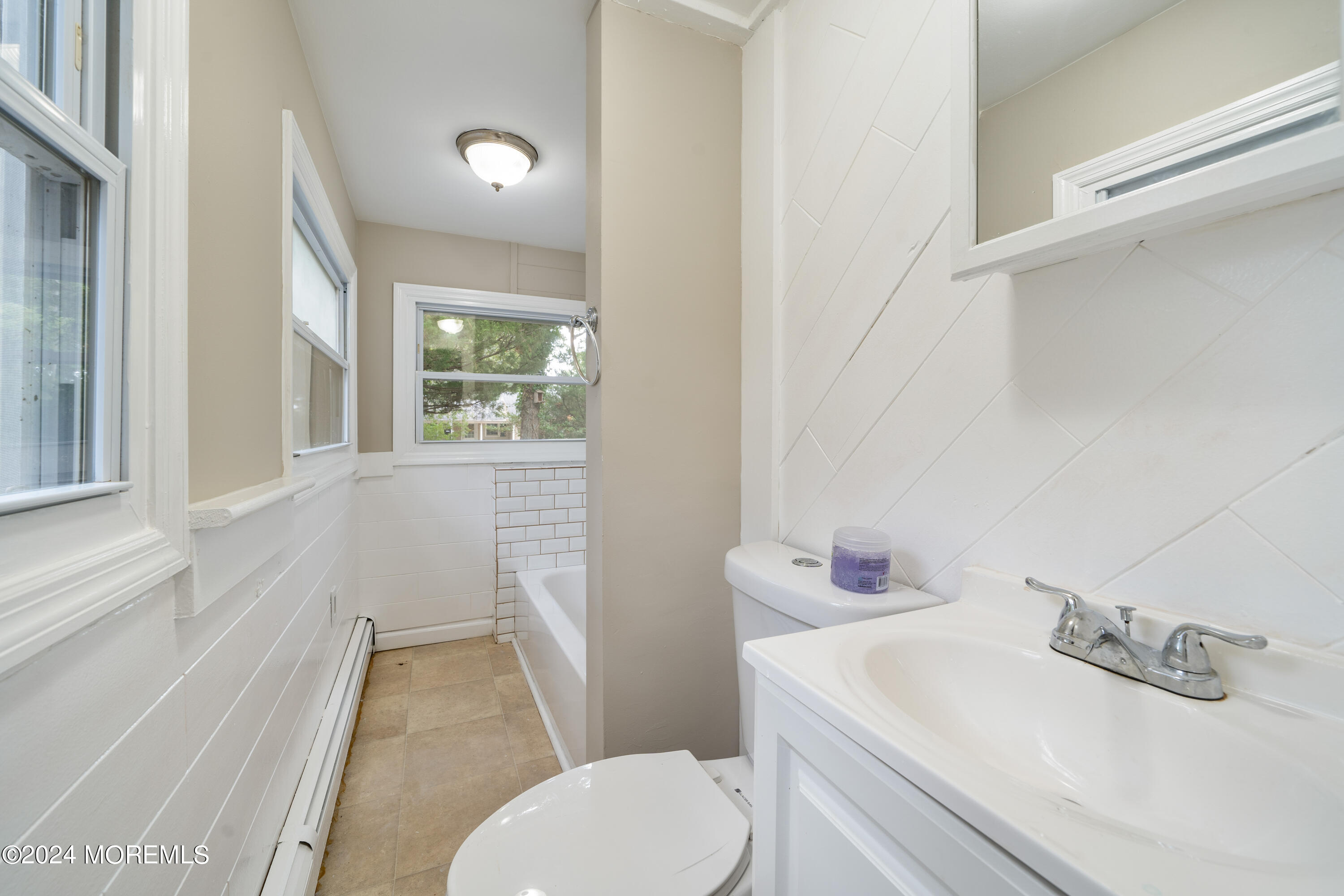 906 Tampa Road Forked River, NJ 08731 - Photo 9 of 21 a bathroom with a sink toilet vanity and tub