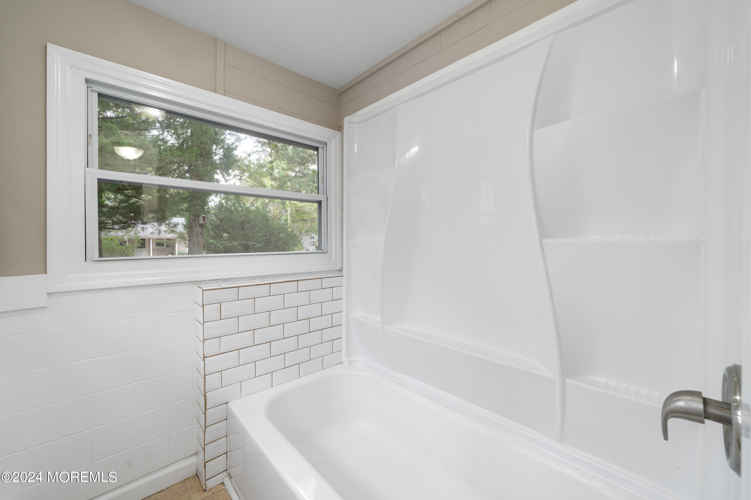 906 Tampa Road Forked River, NJ 08731 - Photo 10 of 21 a bathroom with a bathtub and a shower