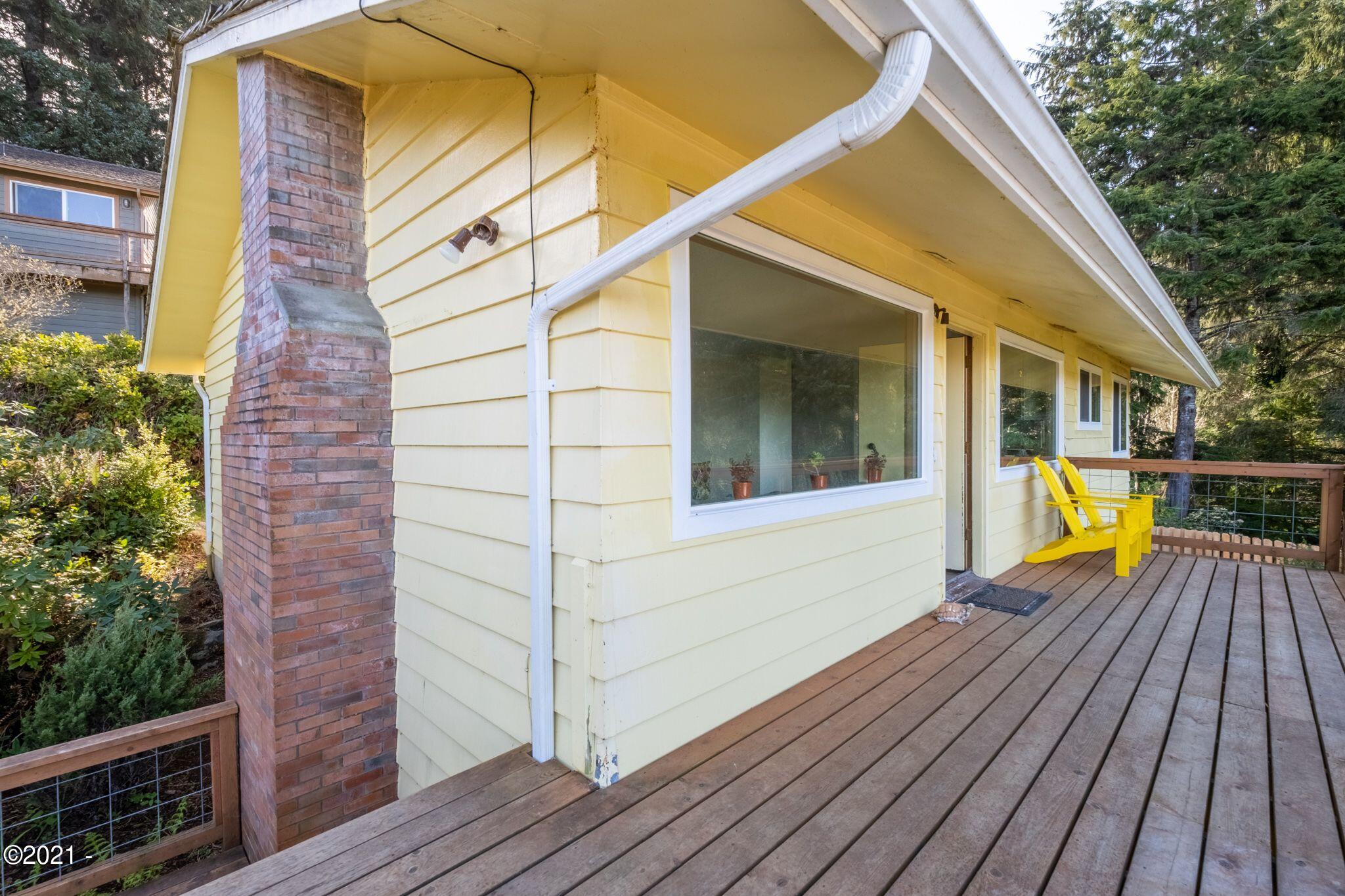 3048 Northeast East Line Road Yachats, OR 97498 - Photo 2 of 31 a view of a house with wooden deck