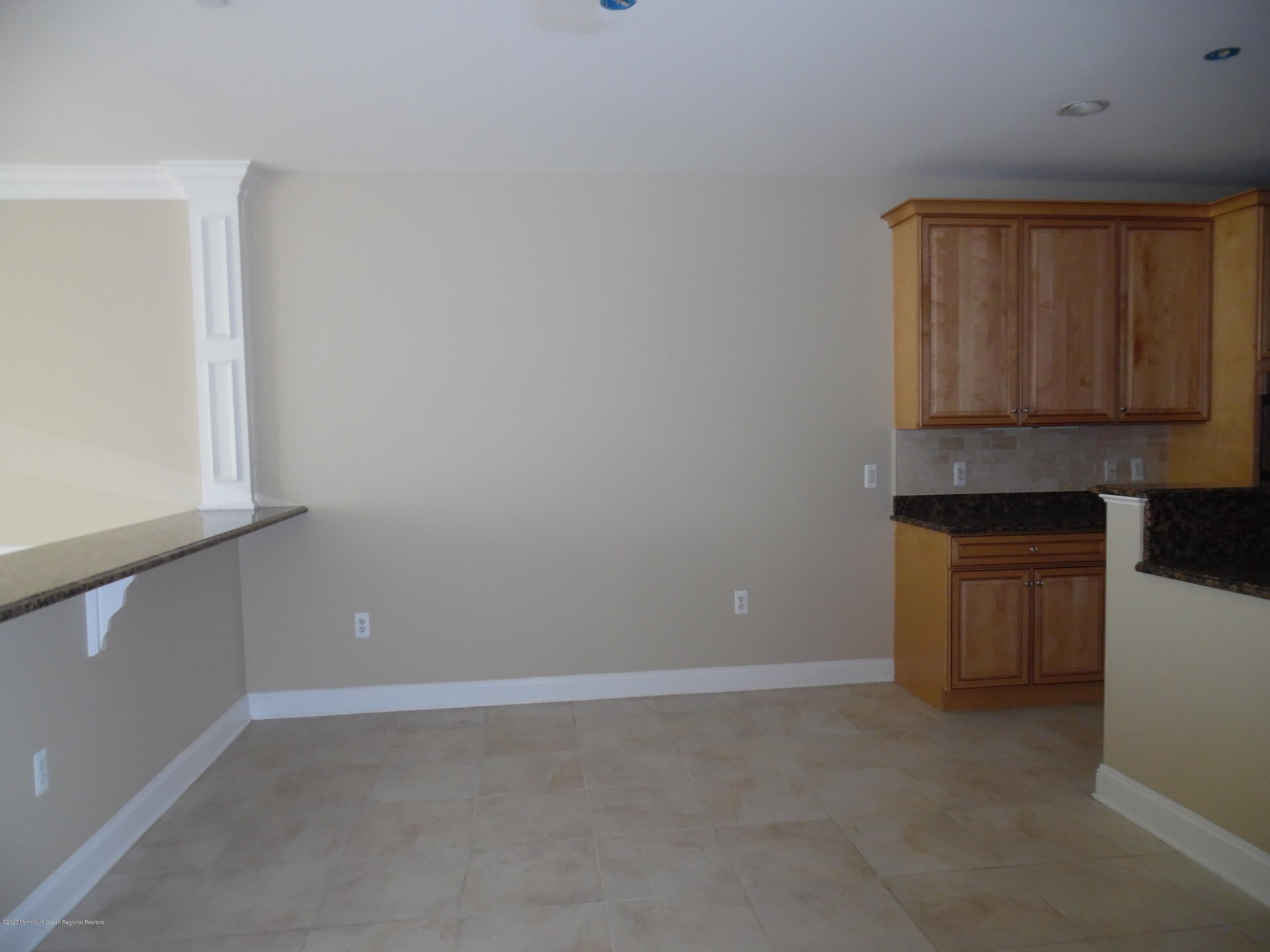 2201 River Road, Unit 2203 Point Pleasant, NJ 08742 - Photo 12 of 23 a room with a microwave and cabinets